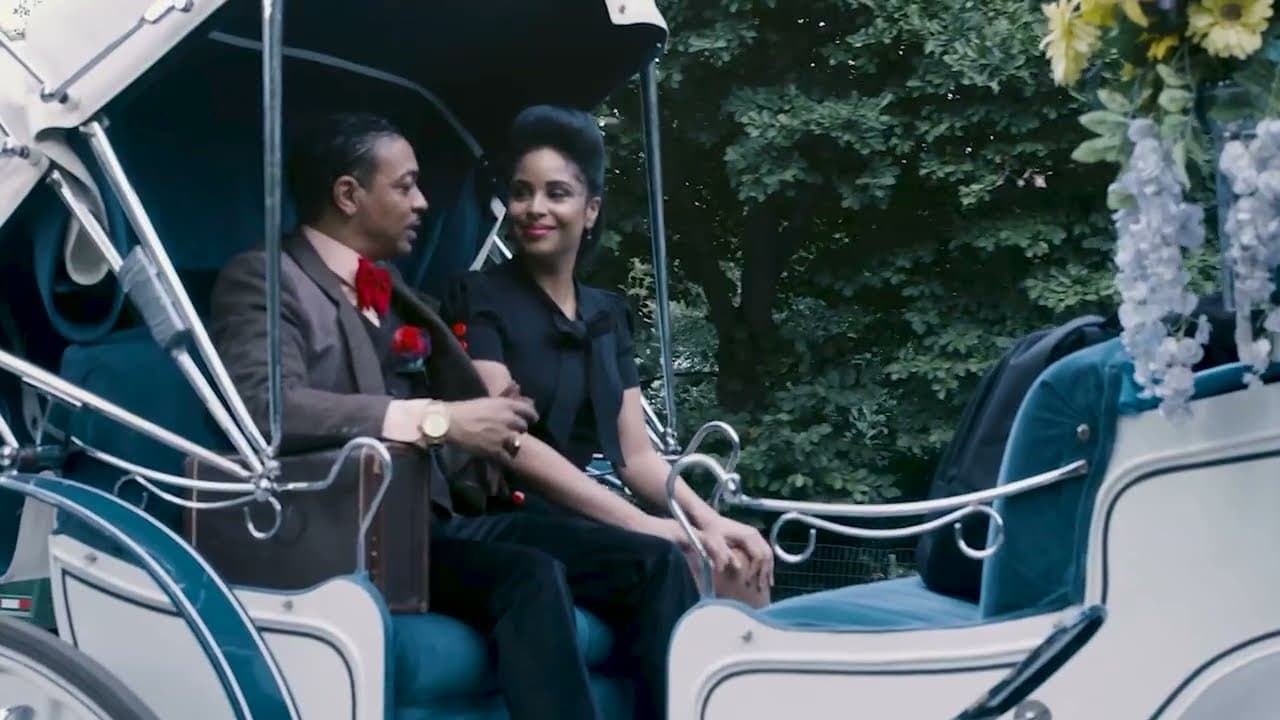 A couple in period dress riding in an open carriage, from the Cab Calloway tribute
